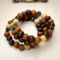 this handmade bracelet is made of 10mm wood beads and is on memory wire, so its like a wrap bracelet, made it with a metal butterfly charm.